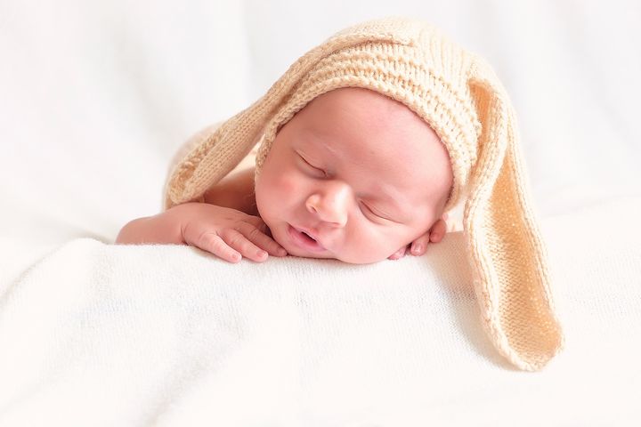 Новорожденный мальчик в шапке с ушками