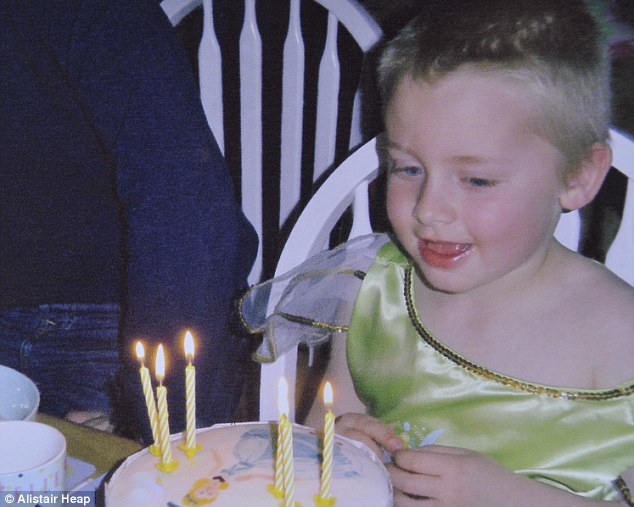 Birthday treat: Livvy blows out candles on her sixth birthday, while wearing a girly green outfit