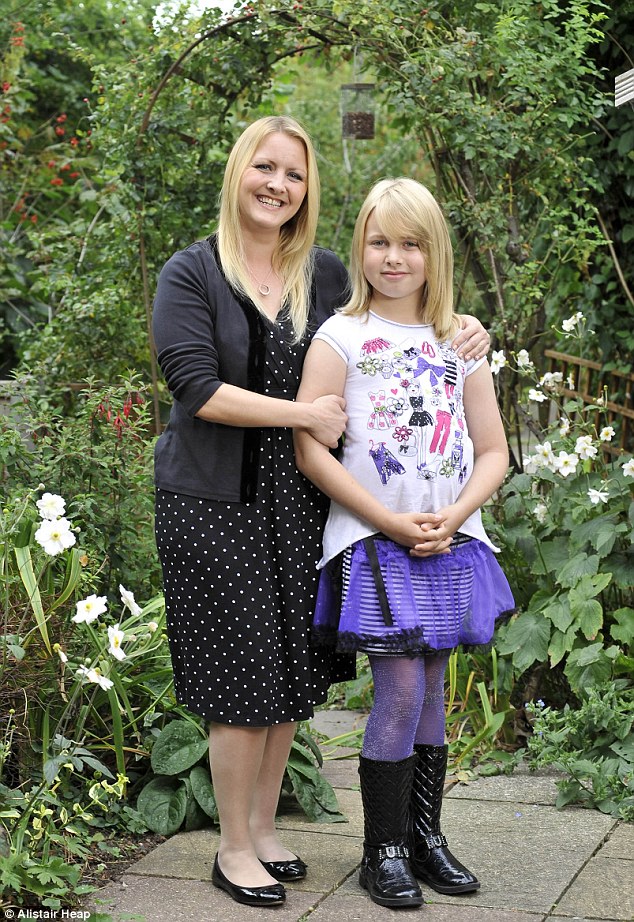 Facing the world: Livvy, who has just returned to Year 6 at school as a girl, stands proudly with her mother Saffron at home in Worcester